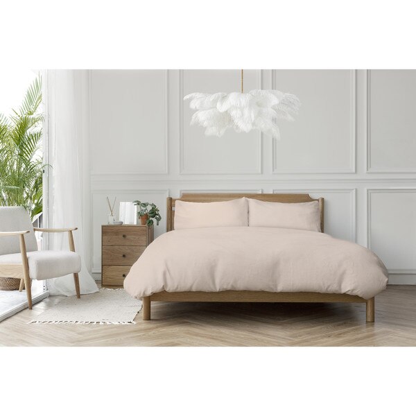 ostrich feather chandelier over a pink and wood bed